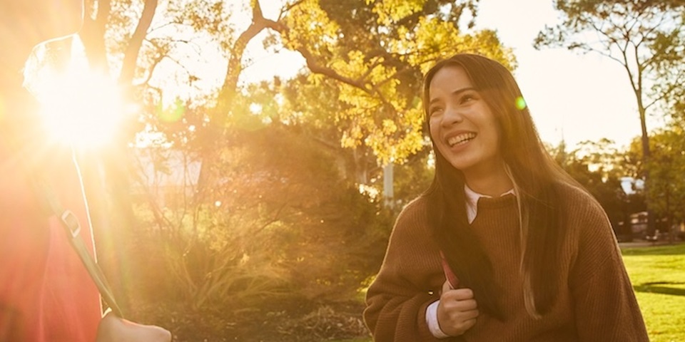 Student smiling with sunlight