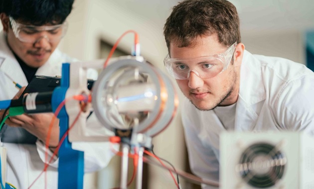 Male physics student working in the lab