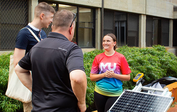 od-solarpanels Staff talking to student and parent about solar energy