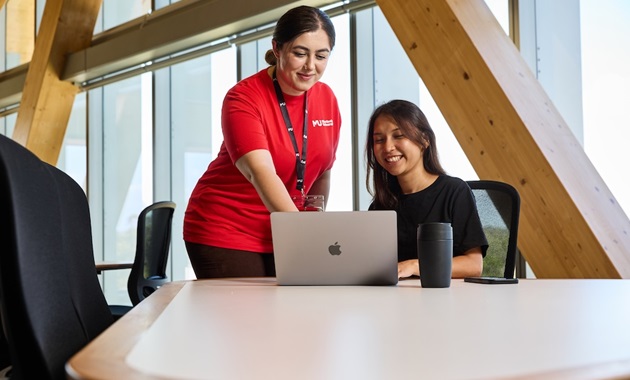 Student Central team helping student with laptop